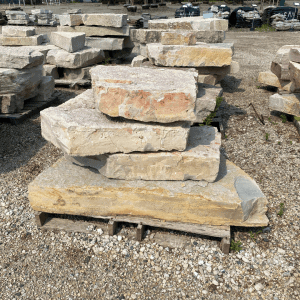 Stacked natural stone slabs at Whispering Hills Nursery.