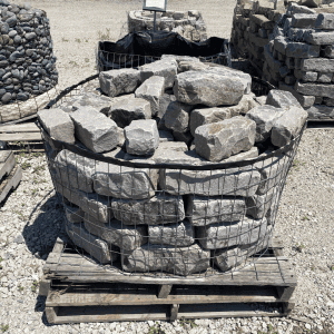 Large basket of irregular gray stone landscape edging at nursery.