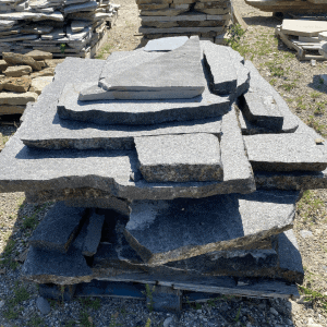 Stacked Whispering Hills Nursery Starlight Black Granite Flagstone slabs.