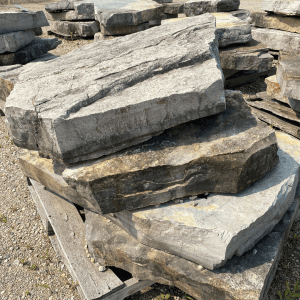 Stacked natural stone slabs for landscaping or construction.