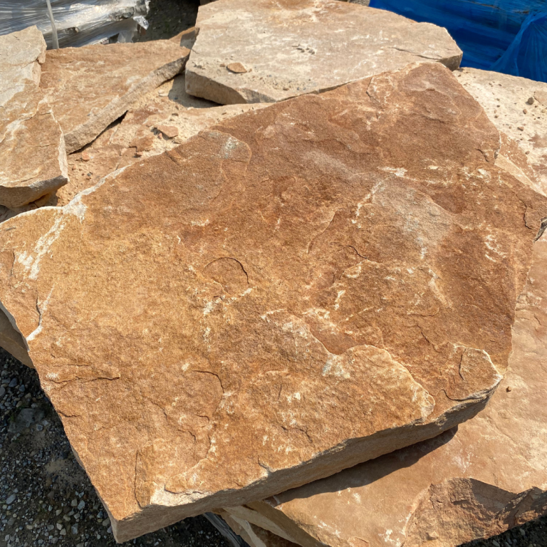 Large natural flagstone with reddish-brown tones for landscaping.