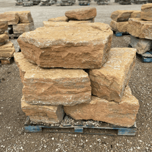 Stack of natural sandstone landscape stones on a pallet.